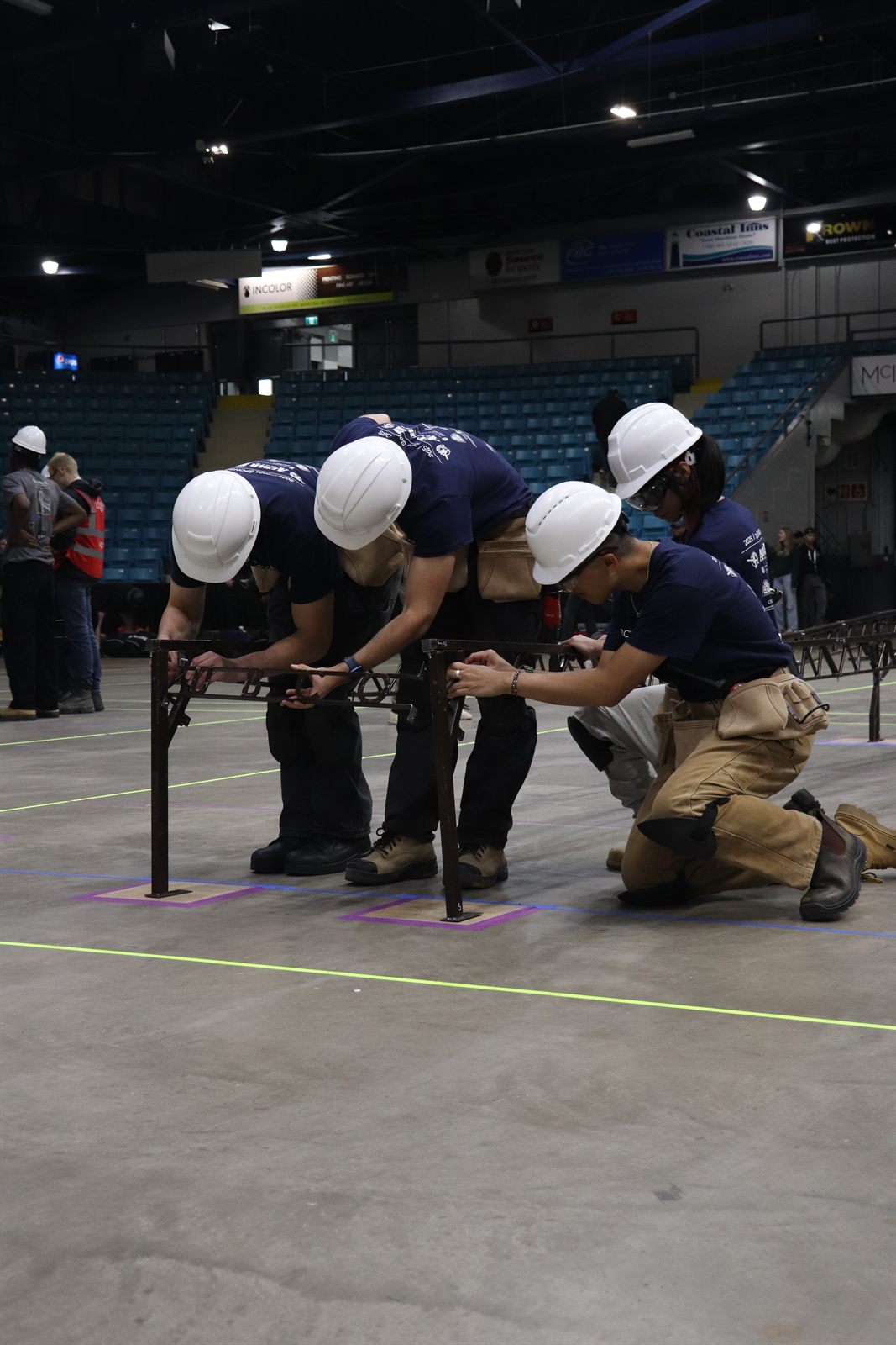 The UBCO team passing bridge members down the line during the timed build