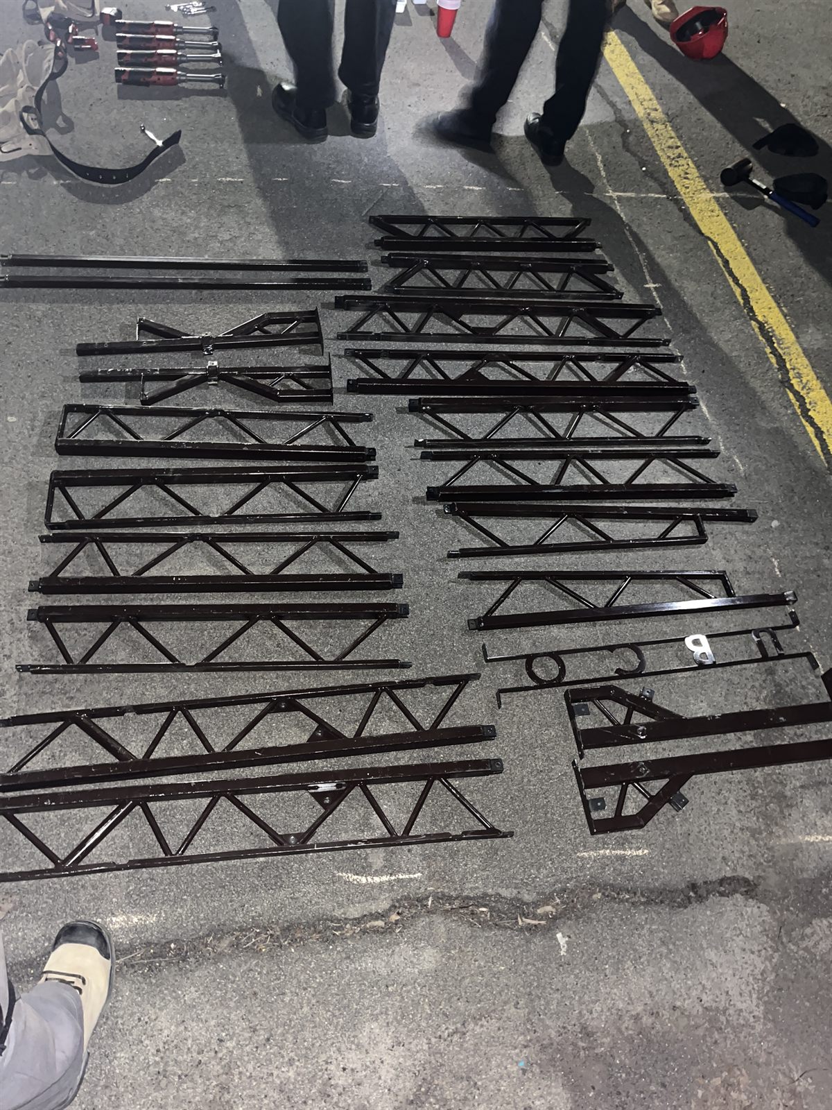 Bridge components and clamps staged on the floor